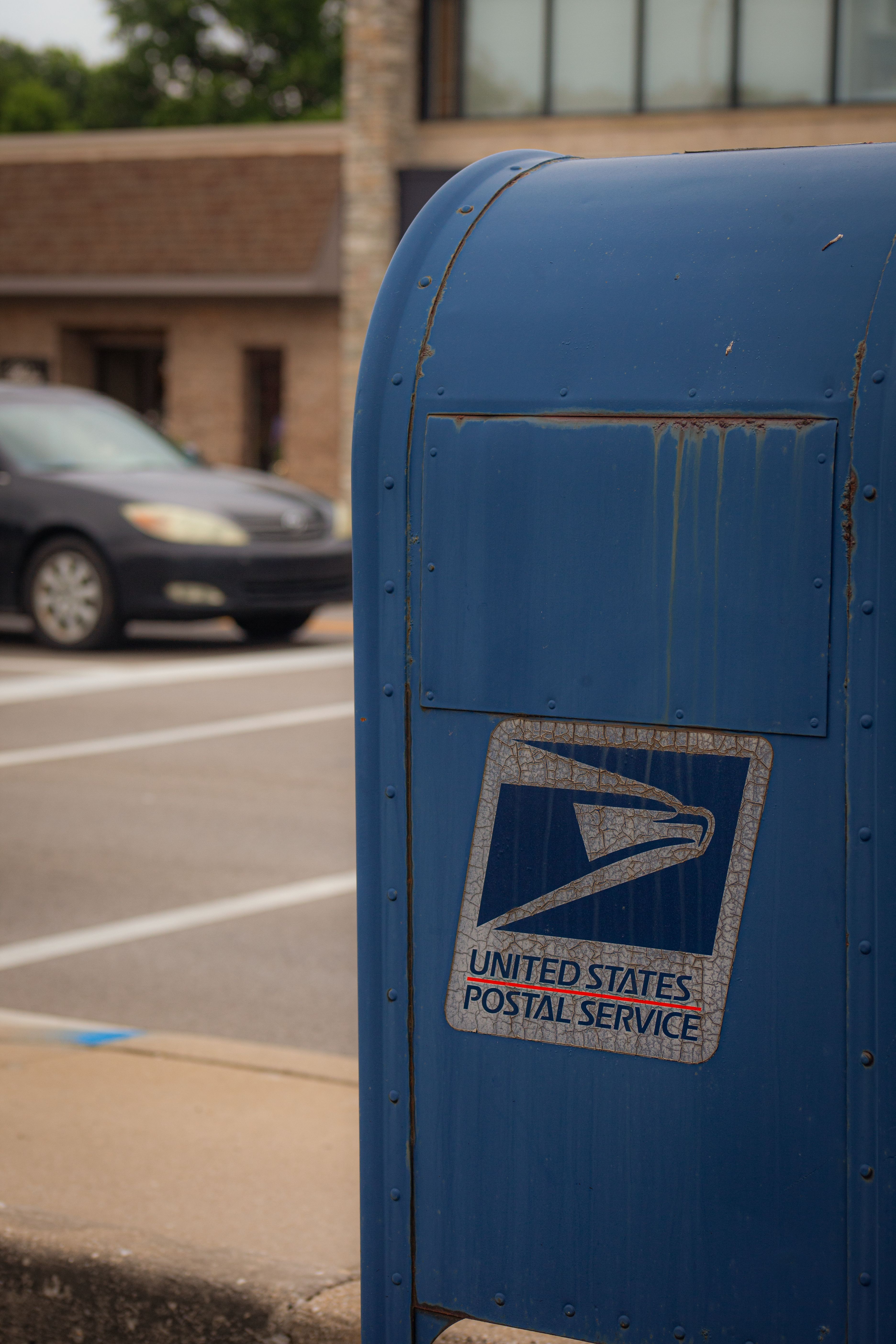 A charming residential mailbox on a garden path — The All monthly letter club
